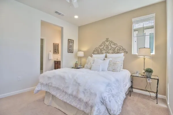 a bedroom with a bed and a painting