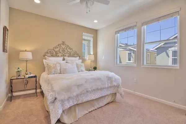a bedroom with a large bed and a chandelier