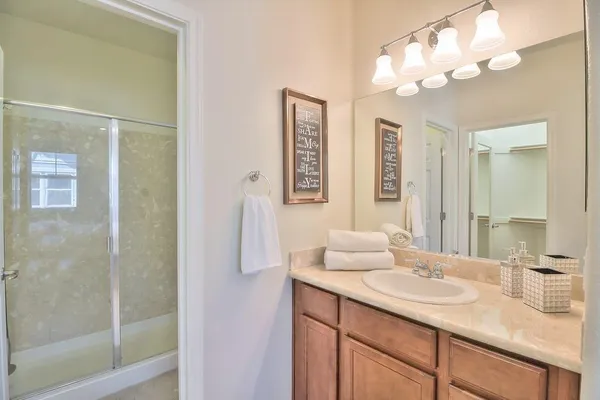 a bathroom with a sink vanity granite and a mirror
