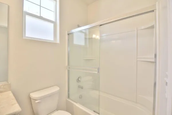 a bathroom with a shower and a toilet
