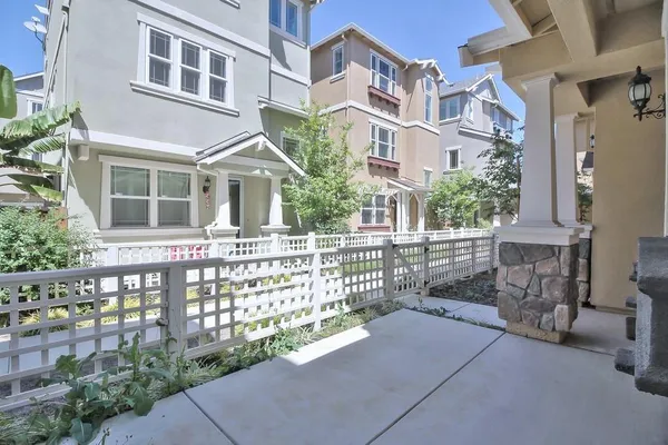 a front view of a house with outdoor space and garden
