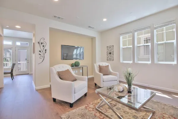 a living room with furniture and a potted plant