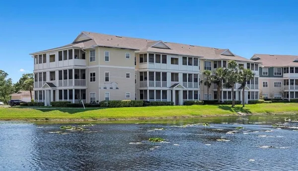 a view of a big yard and a building with a swimming pool