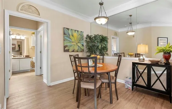 a view of a dining room with furniture and a chandelier