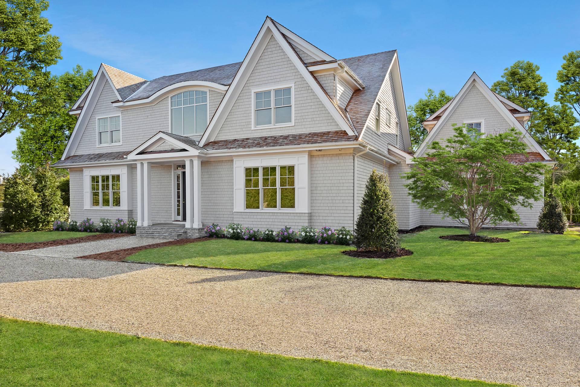 2 Stone Lane Quogue, NY 11959 - Photo 1 of 9 a front view of a house with a yard and garage