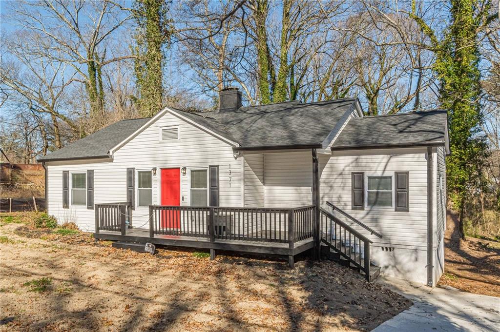 1371 Campbellton Road Southwest Atlanta, GA 30310 - Photo 1 of 1 a view of a house with a yard and wooden fence