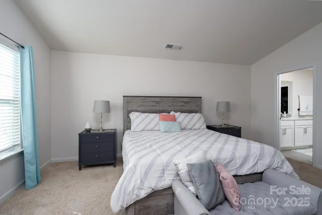 a bedroom with a bed and window