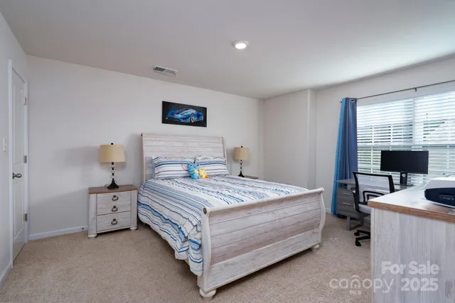 a bedroom with a bed and a desk