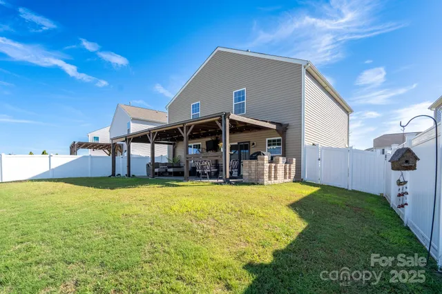 a view of a house with a yard and sitting area