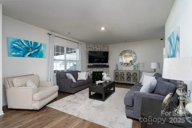 a living room with furniture flat screen tv and a fireplace