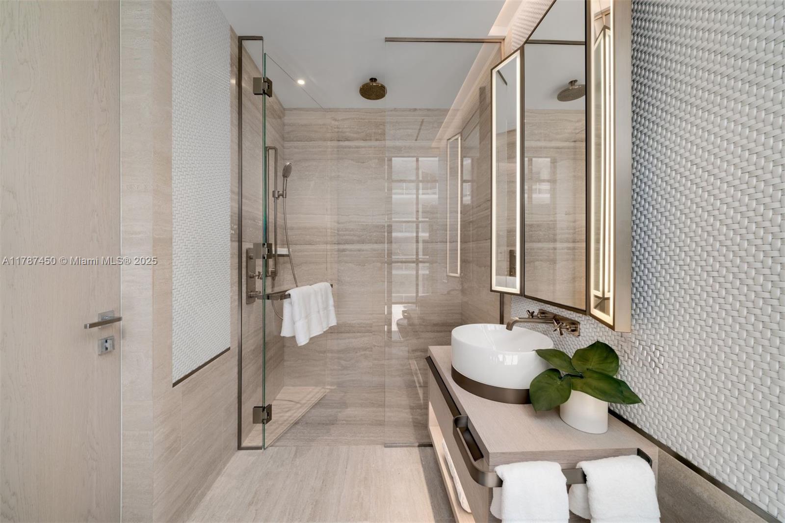 8955 Collins Avenue, Unit 702 Surfside, FL 33154 - Photo 34 of 42 a bathroom with a tub shower and sink