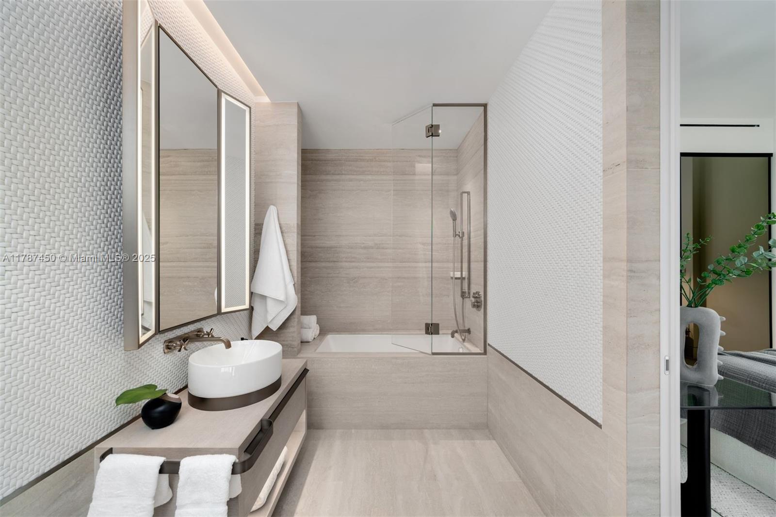 8955 Collins Avenue, Unit 702 Surfside, FL 33154 - Photo 35 of 42 a bathroom with a tub sink and mirror