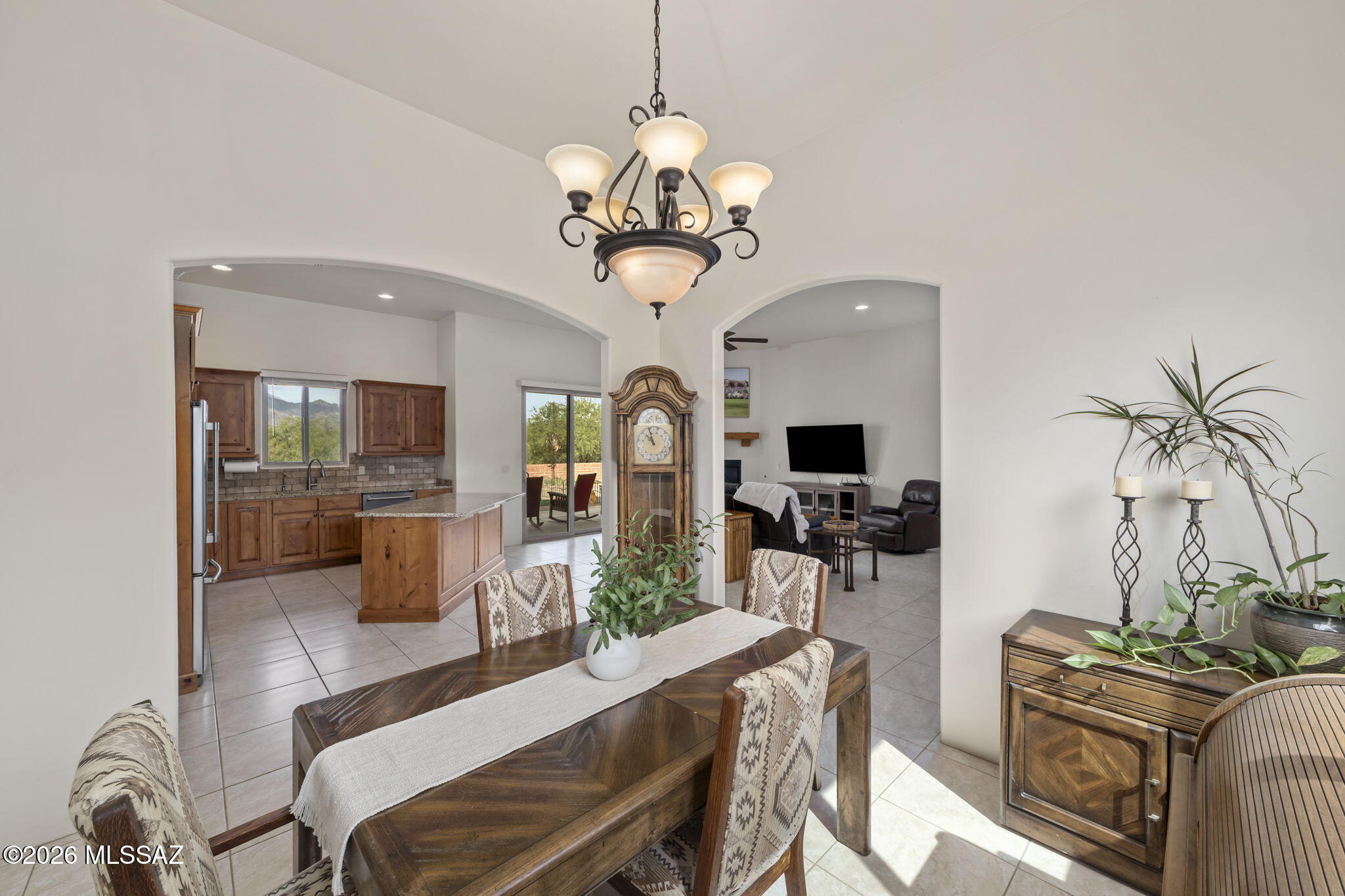 45 High View Court Tubac, AZ 85646 - Photo 14 of 44 a dining room with wooden floor a chandelier a wooden table and chairs
