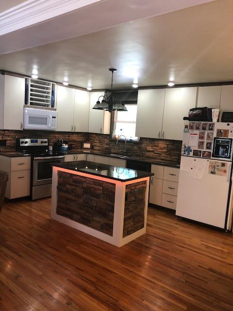 1087 Jackson Heights Road Goodlettsville, TN 37072 - Photo 4 of 23 a kitchen with stainless steel appliances wooden floor sink and stove