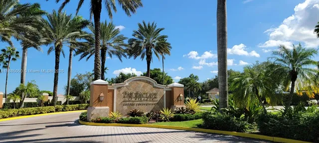 a view of a house with palm trees