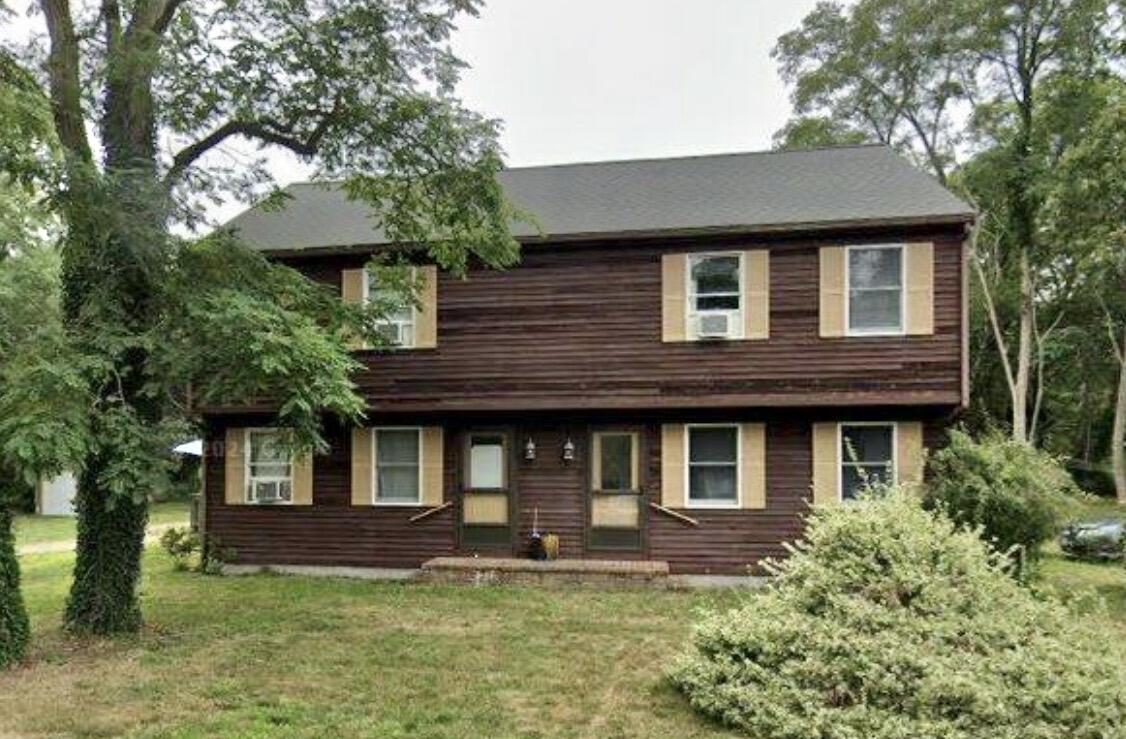 a front view of a house with a yard