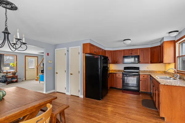 a kitchen with stainless steel appliances granite countertop a refrigerator a stove and a sink