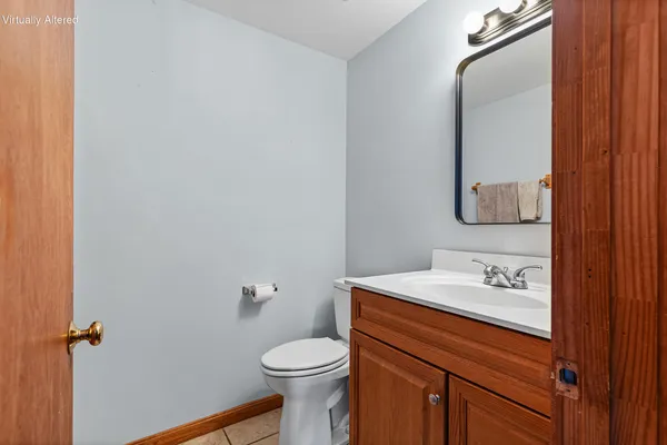 a bathroom with a sink vanity mirror and toilet