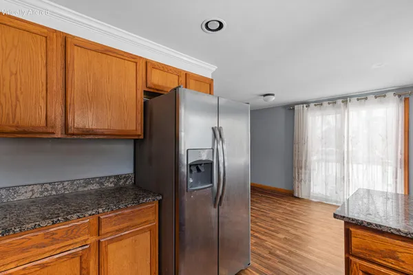 a kitchen with stainless steel appliances granite countertop a refrigerator and a sink
