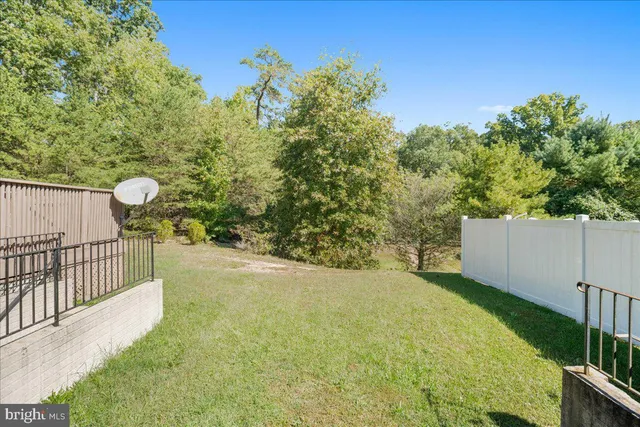 an aerial view of a house with a swimming pool and outdoor seating