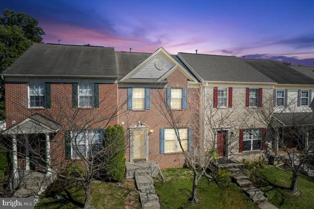 a view of a brick house with a yard