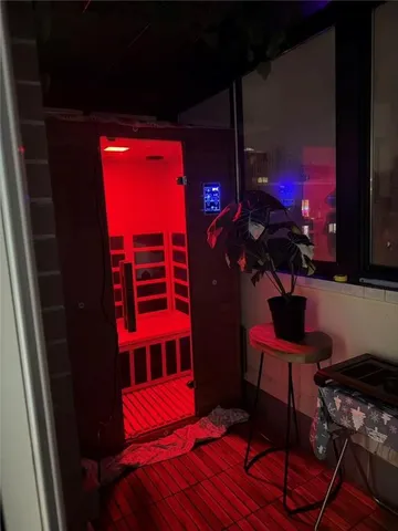 a view of balcony with two chairs and a potted plant