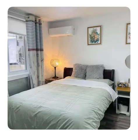 a bedroom with a bed and a painting on the wall