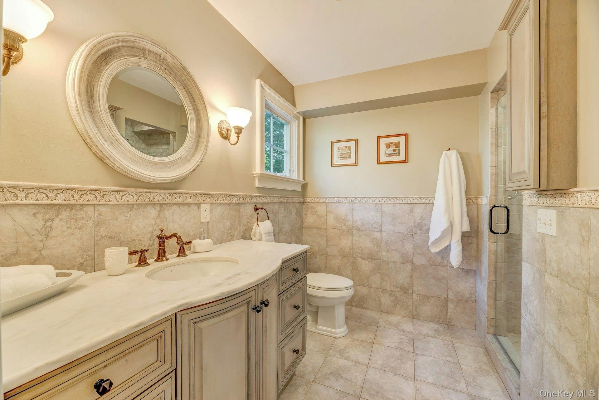 3600 Rocky Point Road East Marion, NY 11939 - Photo 17 of 45 a bathroom with a sink a toilet and a mirror