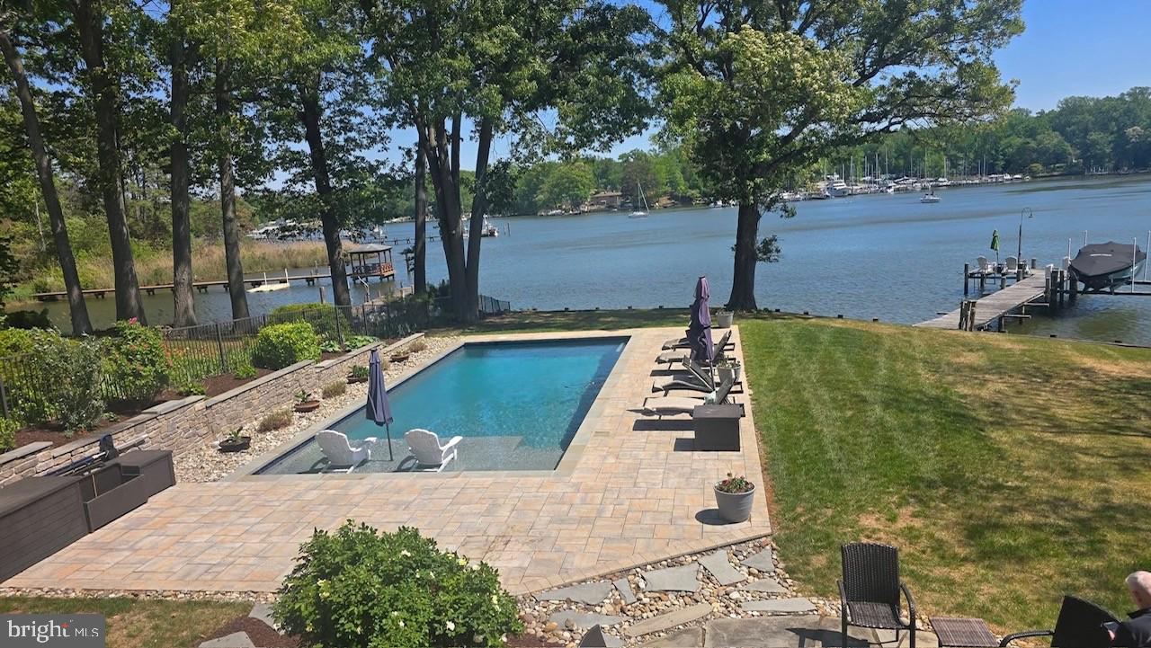 Serene waterfront retreat with pool.