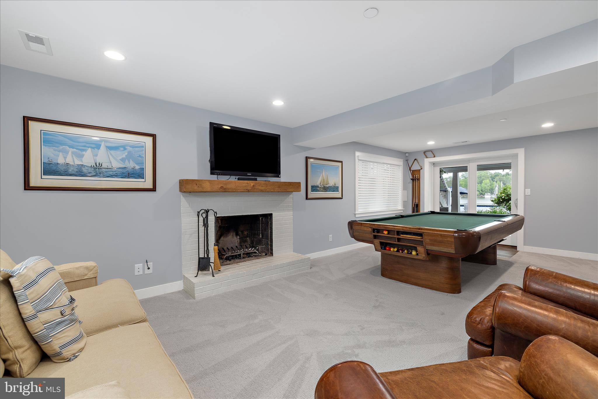 3815 Outrigger Drive Edgewater, MD 21037 - Photo 49 of 114 a living room with furniture a flat screen tv and a fireplace