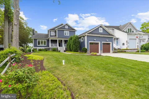 a kitchen with stainless steel appliances granite countertop a kitchen island a stove and a sink