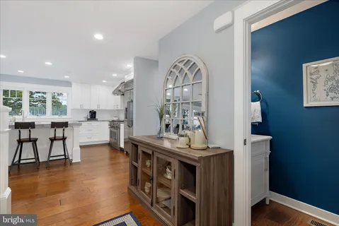 a kitchen with stainless steel appliances granite countertop a refrigerator a stove and a sink