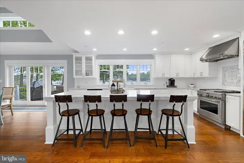 a dining room with furniture window and wooden floor
