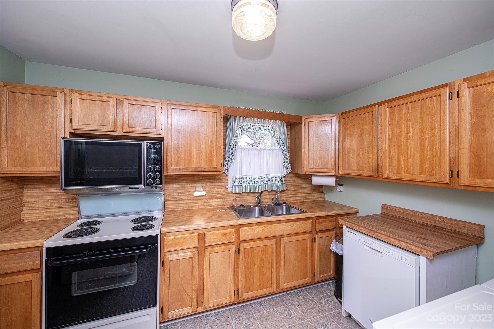 5116 Grapevine Drive Charlotte, NC 28217 - Photo 6 of 14 a kitchen with stainless steel appliances granite countertop a stove a sink and a microwave