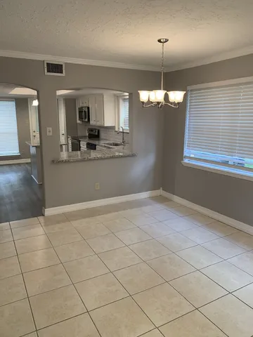 a view of a dining room with furniture and window
