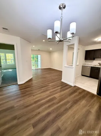 a view of a room with wooden floor