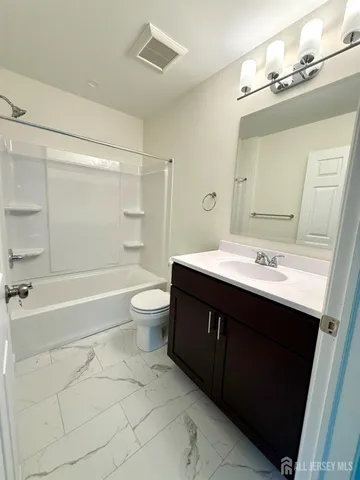 a bathroom with a sink a toilet and a bathtub