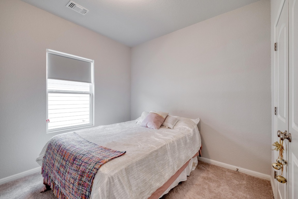 19425 Forman Drive Pflugerville, TX 78660 - Photo 15 of 25 a bedroom with a bed and a window