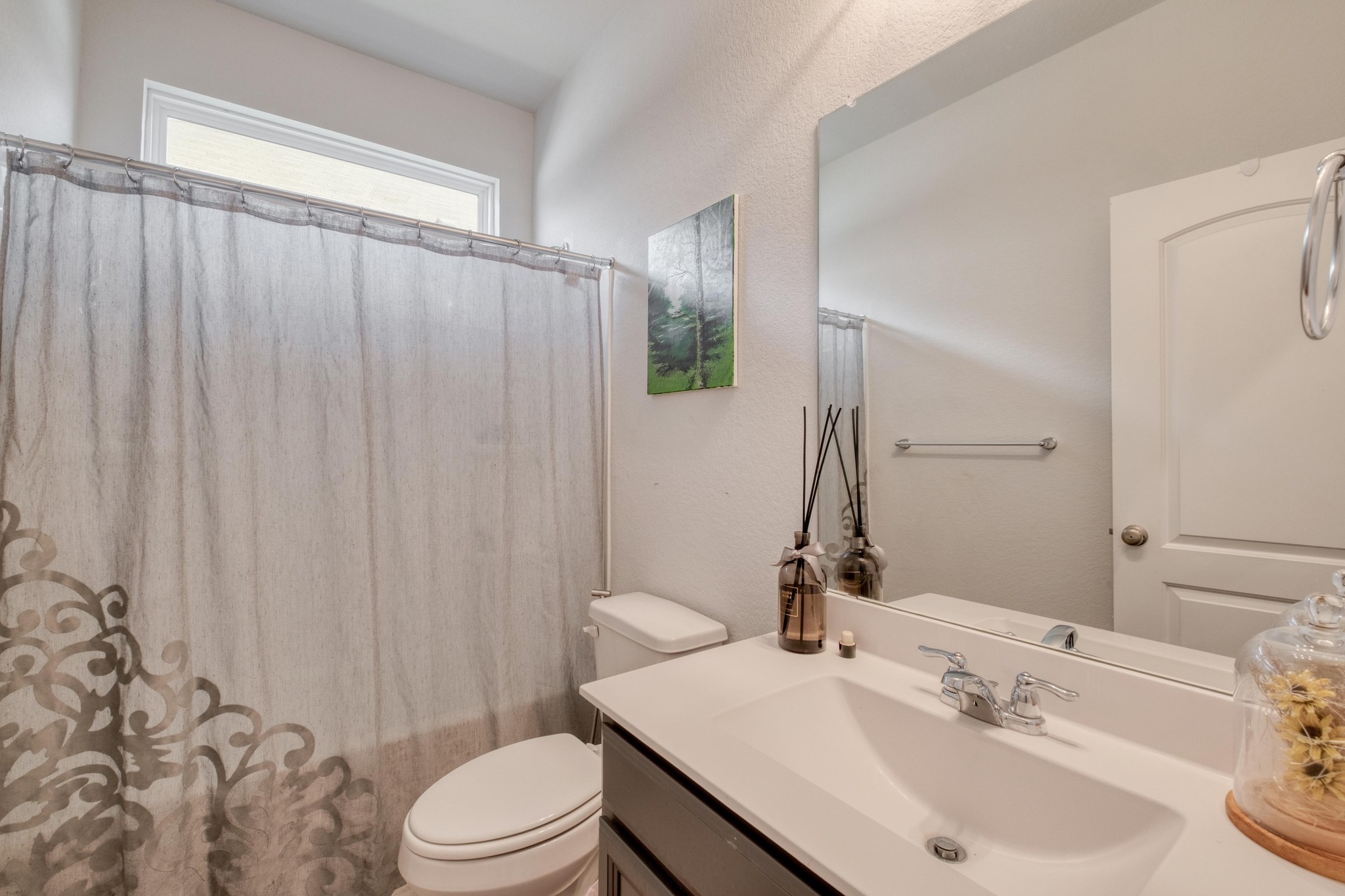 19425 Forman Drive Pflugerville, TX 78660 - Photo 17 of 25 Bathroom with vanity, a textured wall, and shower / tub combo with curtain