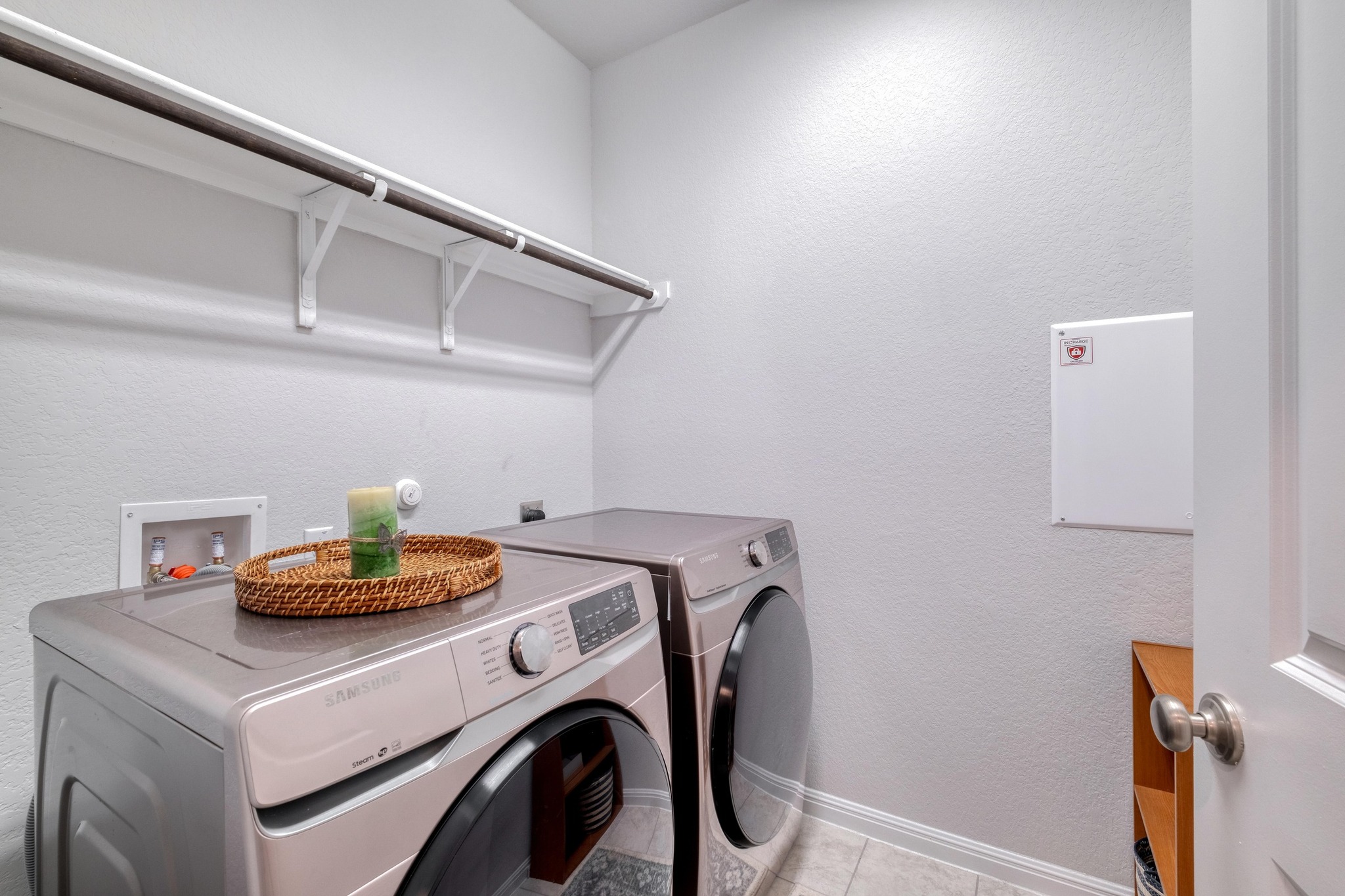 19425 Forman Drive Pflugerville, TX 78660 - Photo 19 of 25 Laundry area featuring a textured wall, light tile patterned floors, and washer and clothes dryer