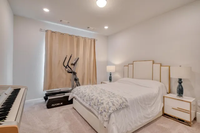 a bedroom with a bed and a dresser