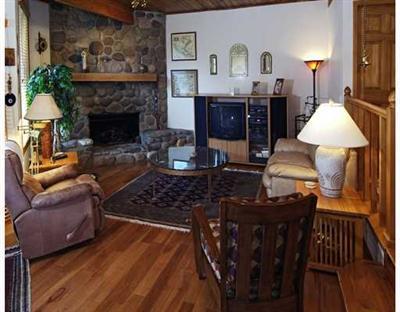 2335 Bald Mountain Road, Unit 12 Vail, CO 81657 - Photo 1 of 8 a living room with furniture a lamp and a fireplace