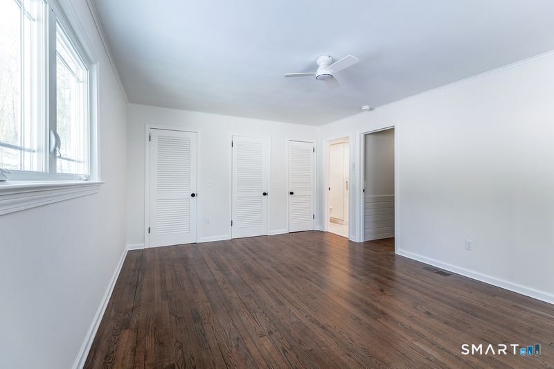 102 Wykeham Road Washington, CT 06793 - Photo 14 of 24 a view of an empty room with wooden floor and a window