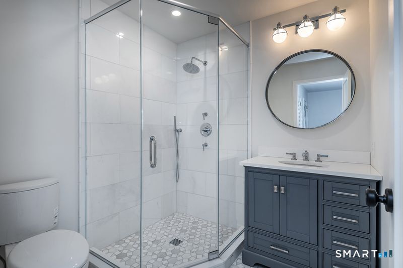 102 Wykeham Road Washington, CT 06793 - Photo 16 of 24 a bathroom with a toilet a sink and mirror