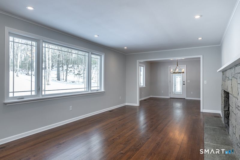 102 Wykeham Road Washington, CT 06793 - Photo 8 of 24 a view of an empty room with wooden floor and a window