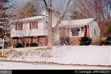 8522 Valleyfield Road Lutherville-Timonium, MD 21093 - Photo 1 of 1 a view of a white house with a yard covered in snow