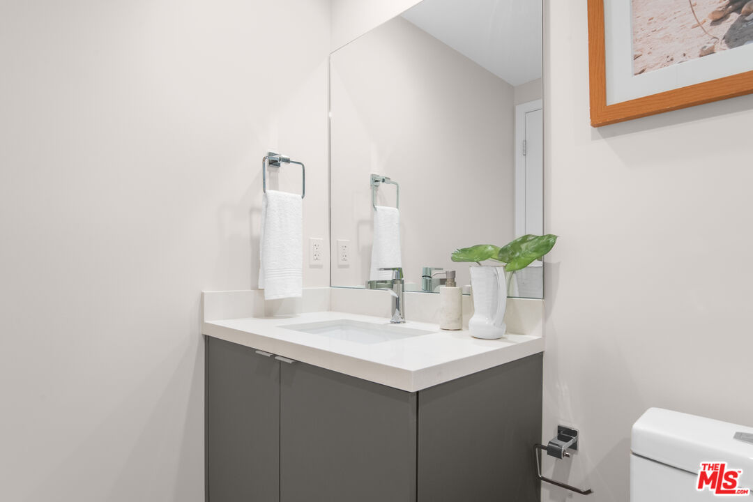1226 South Bedford Street, Unit 502 Los Angeles, CA 90035 - Photo 12 of 16 a bathroom with a sink and a mirror