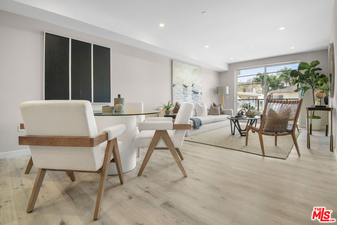 1226 South Bedford Street, Unit 502 Los Angeles, CA 90035 - Photo 3 of 16 a living room with furniture and a large window