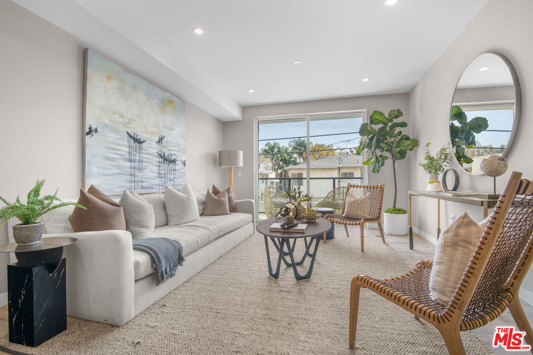1226 South Bedford Street, Unit 502 Los Angeles, CA 90035 - Photo 5 of 16 a living room with furniture and a large window