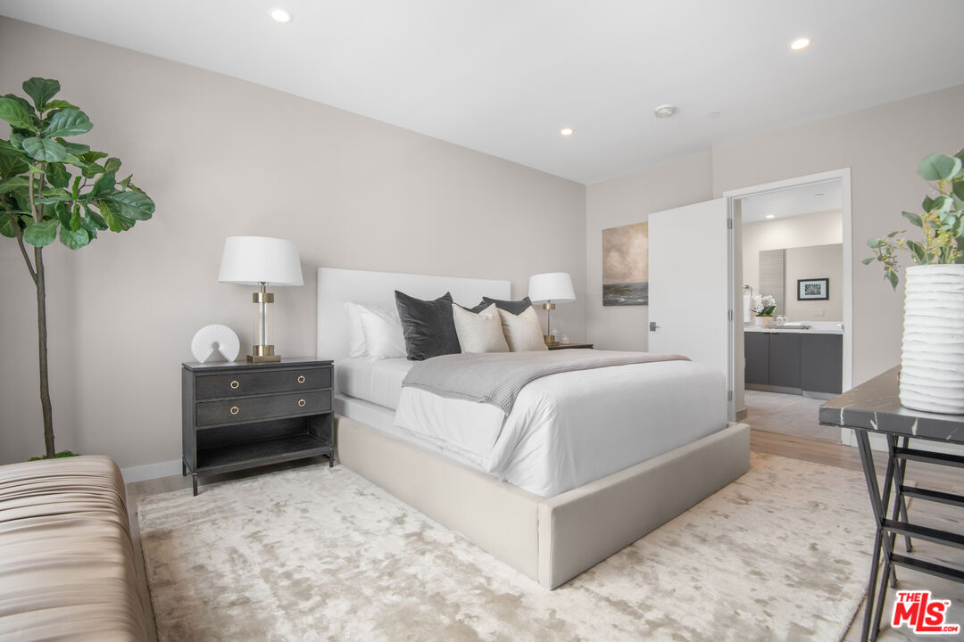 1226 South Bedford Street, Unit 502 Los Angeles, CA 90035 - Photo 8 of 16 a bedroom with a bed and a potted plant